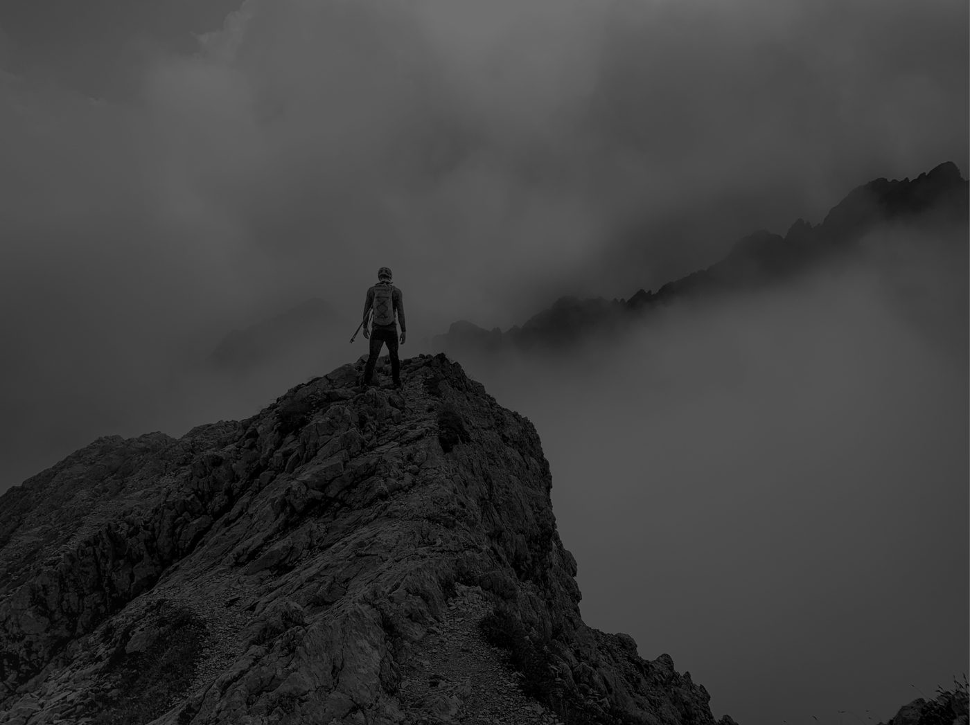 Hiker on a misty mountain ridge